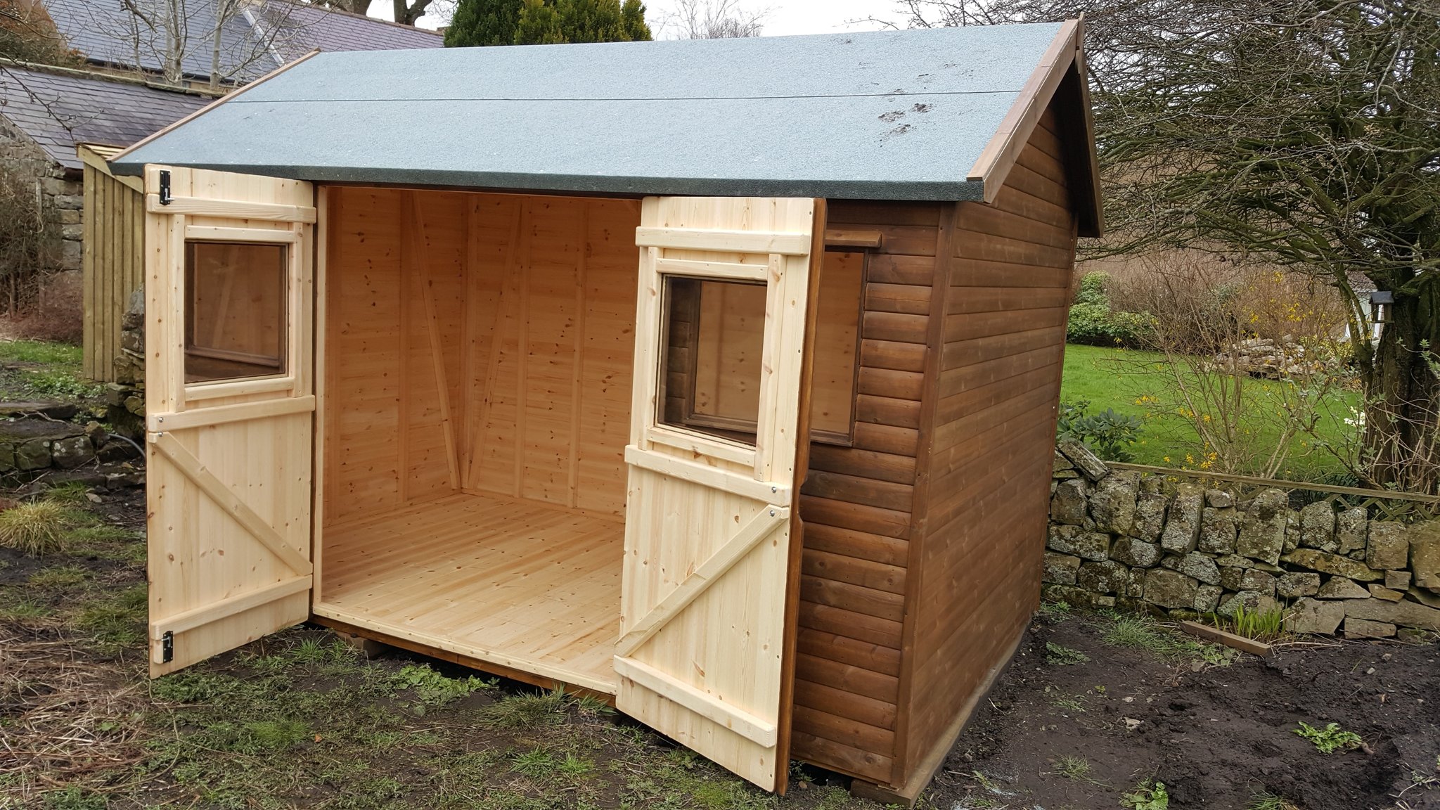 Workshop shed with the double doors open showing the floor