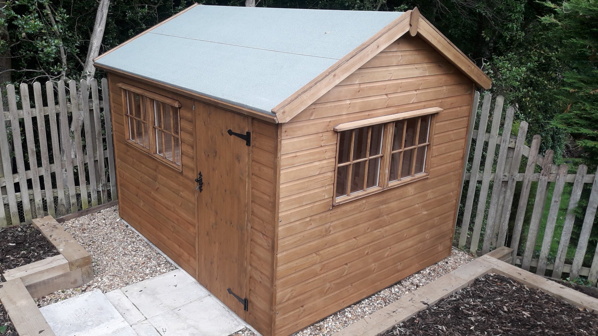 Stained apex shed with small paned windows