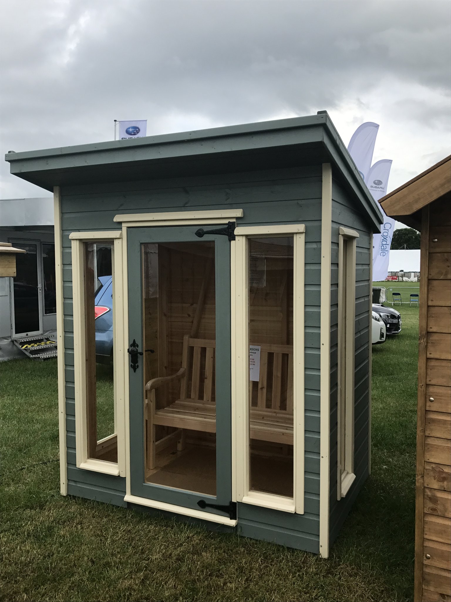 Sage pent summer house with glazed doors on show